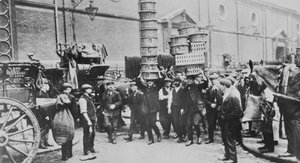 View of expert basket carriers and a group of market men, 1900 by English Photographer